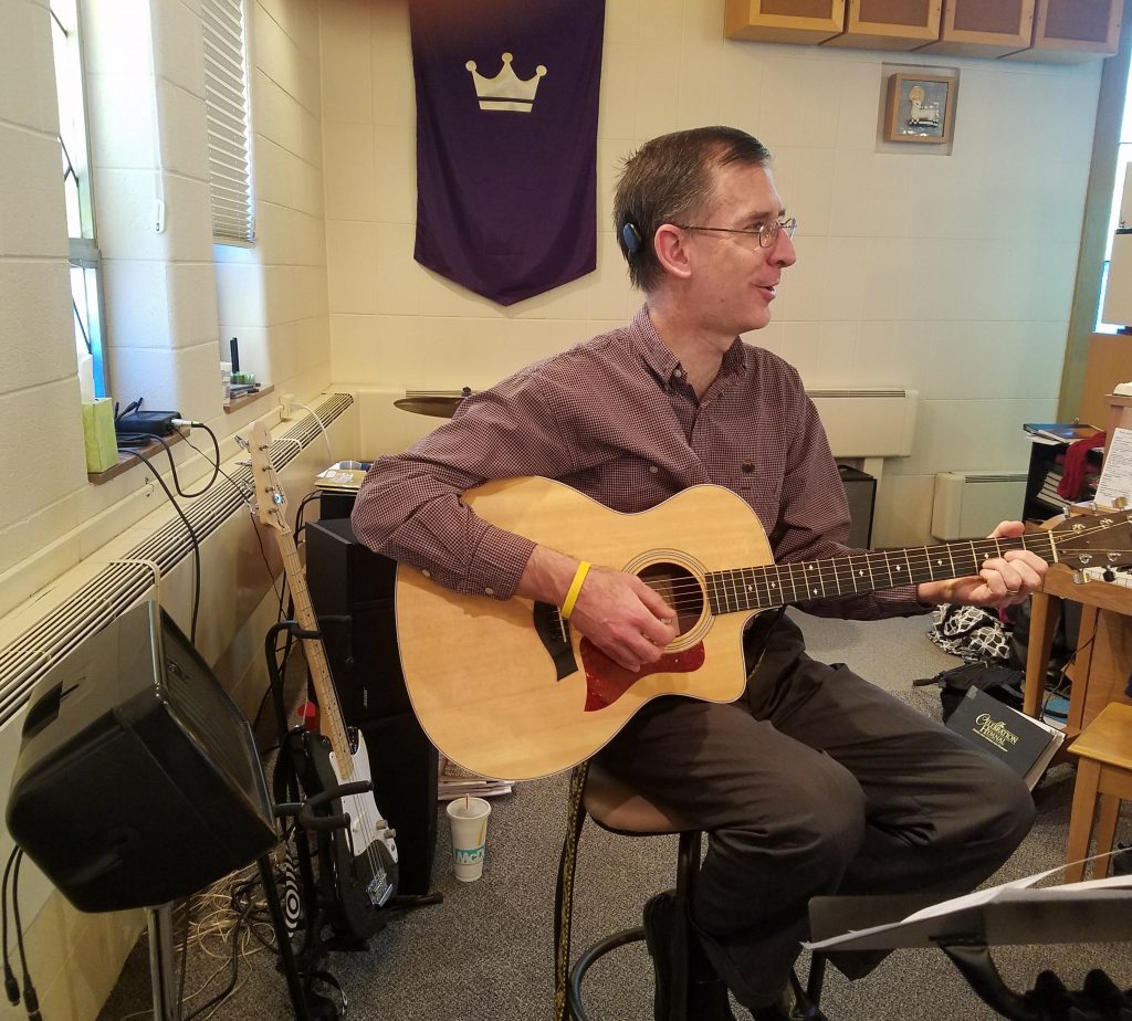 Cochlear implant recipient John playing guitar