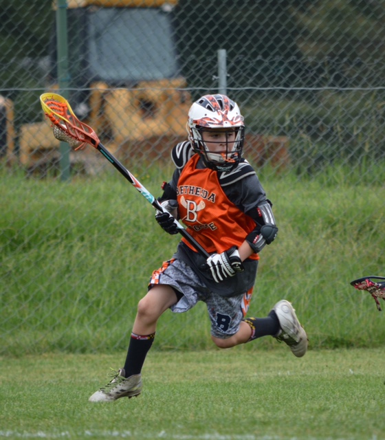 Christian playing lacrosse