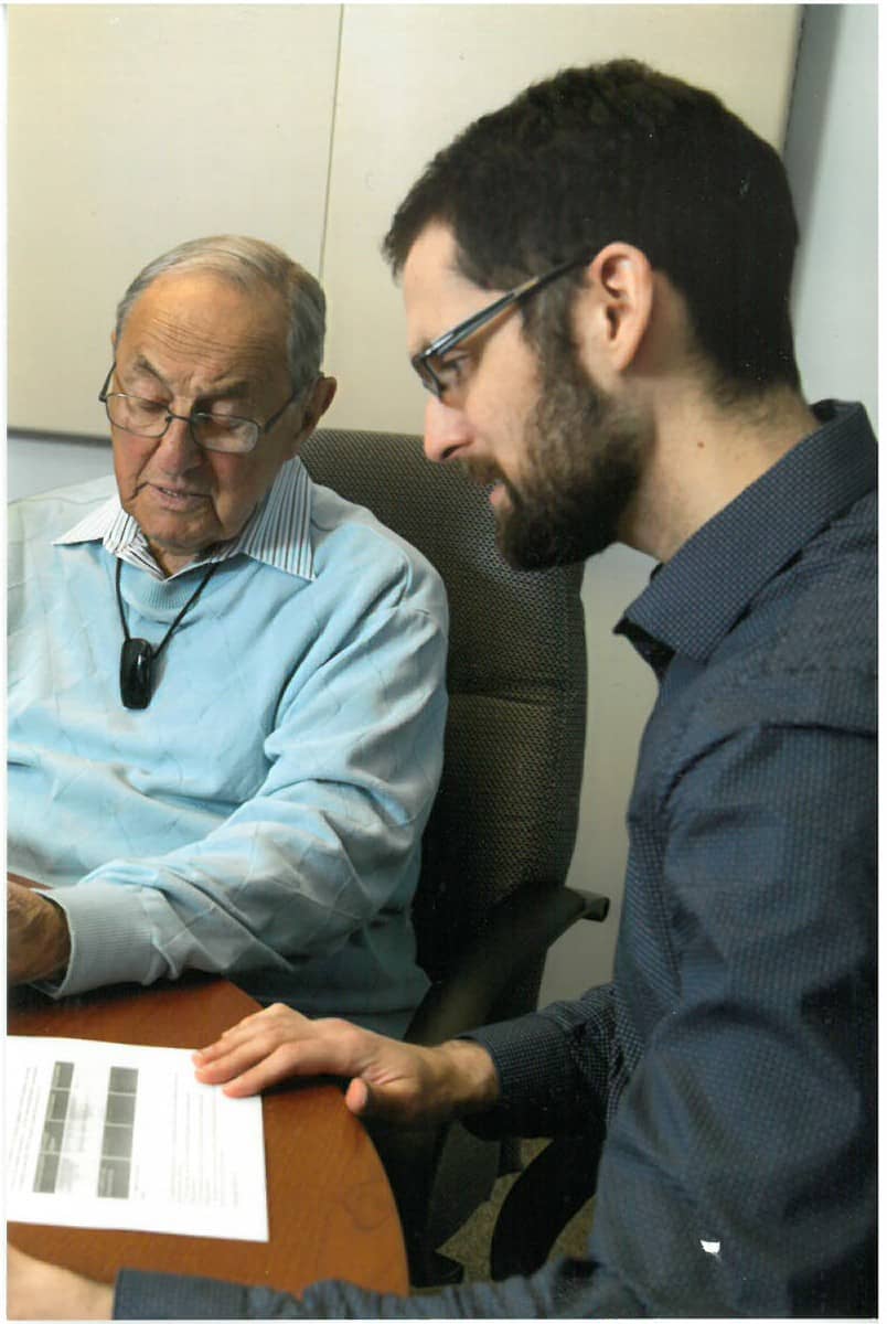 Bruce D., a veteran with hearing loss, with a student