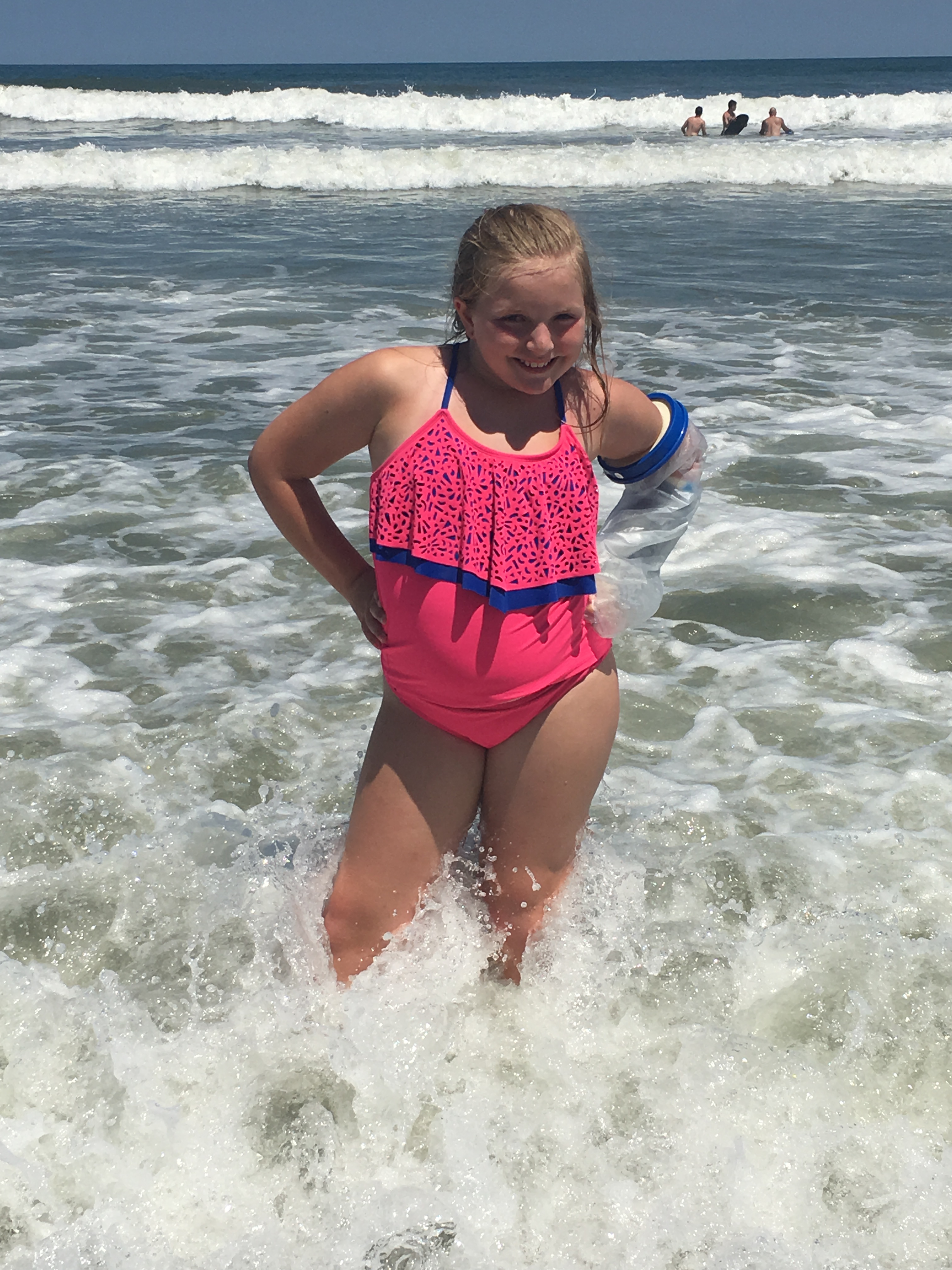 Katie at the beach after having had meningitis and hearing loss