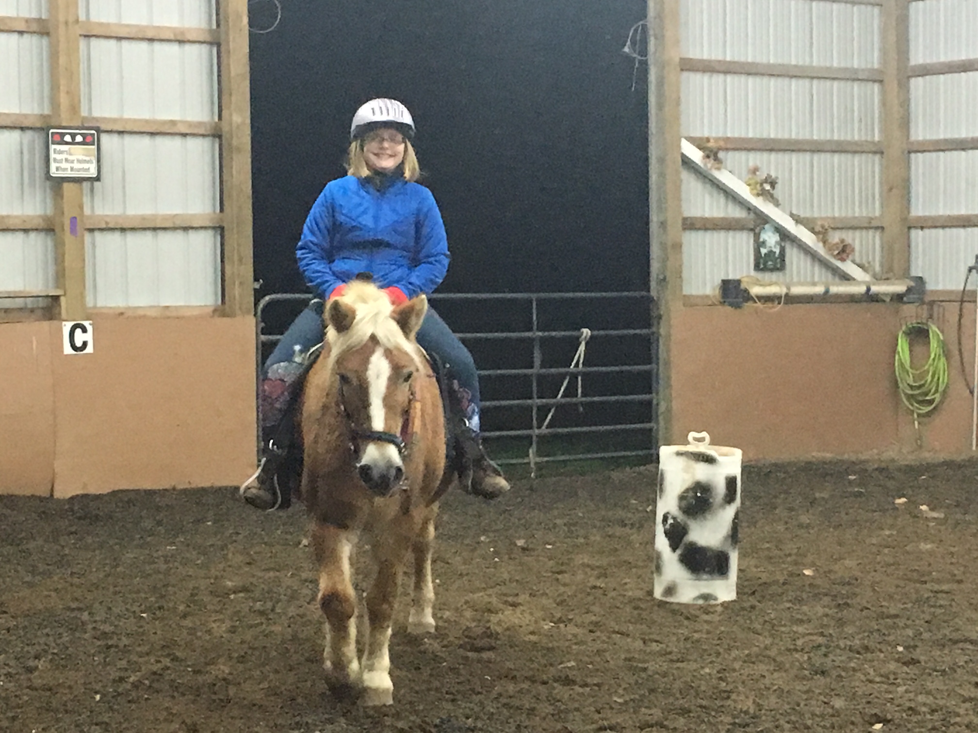 Katie riding a horse after having meningitis and hearing loss