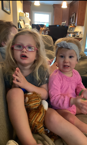 Carly, with her sister, with profound hearing loss
