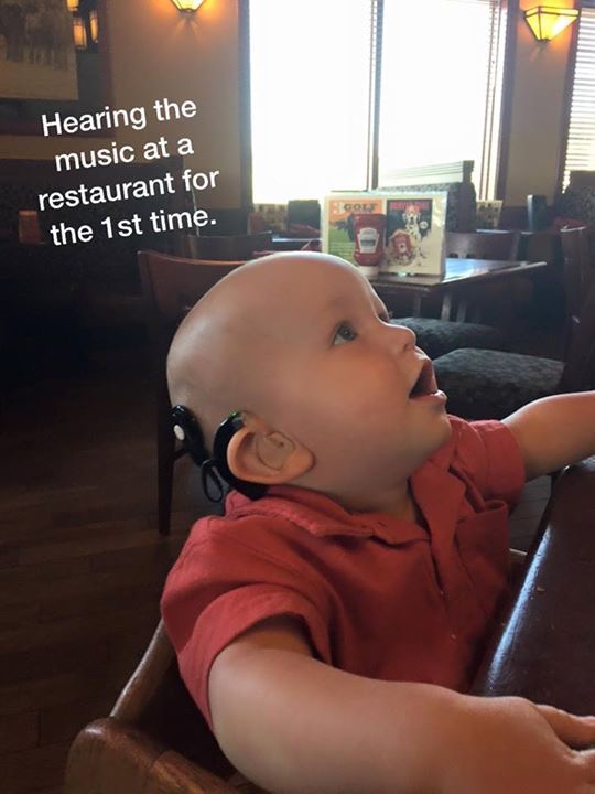 child with connexin 26 gene mutation at a restaurant