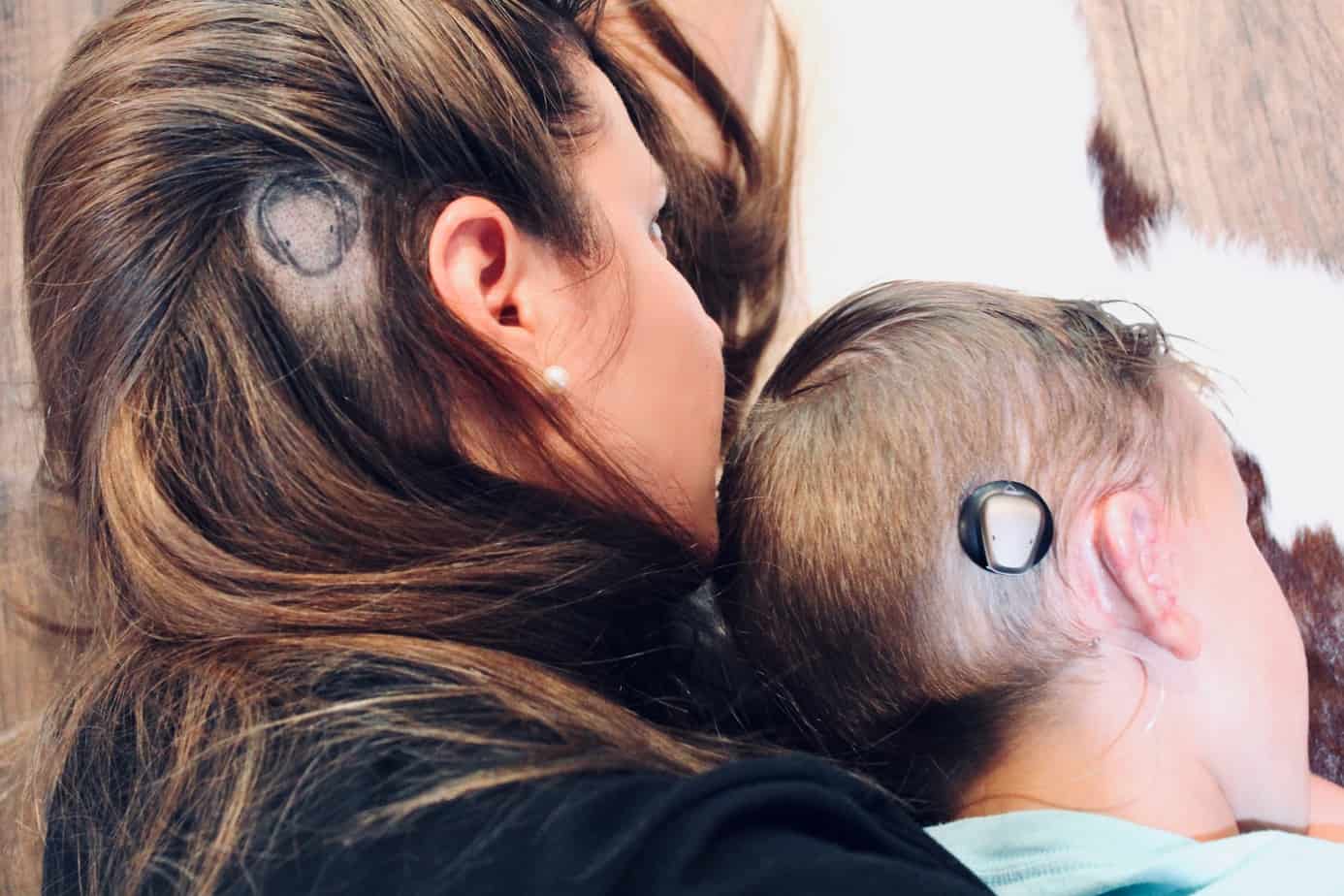 Mom with tattoo celebrating child with ear malformation at birth