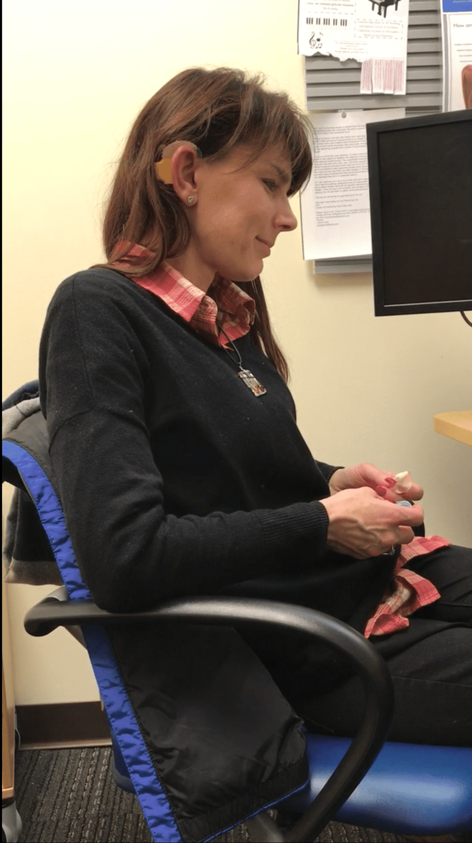 Woman with severe to profound hearing loss at her cochlear implant activation appointment