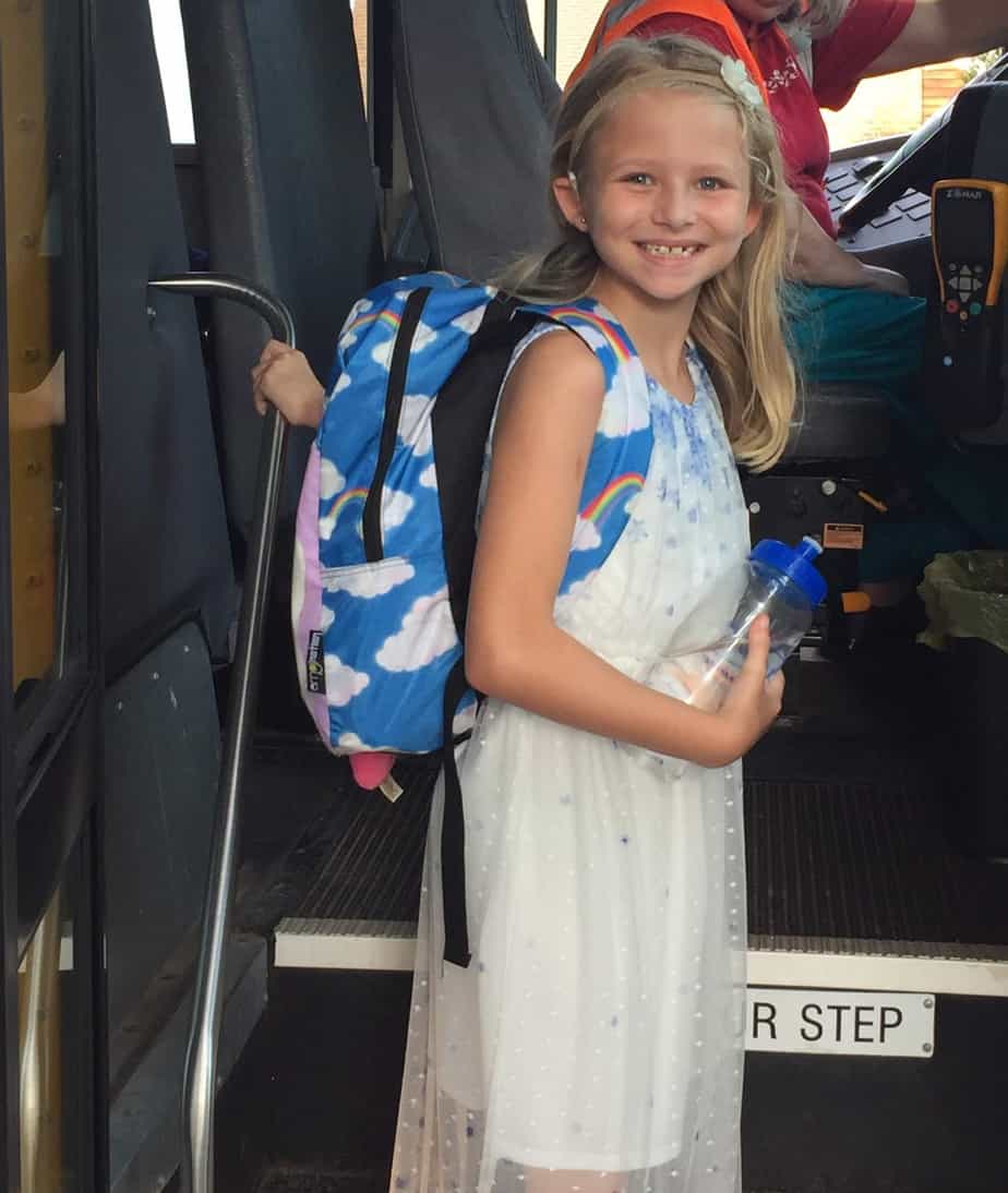 Casey, a child with progressive hearing loss, getting on the bus