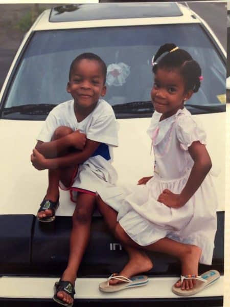 Child Charlene Cohen-DeRoy sitting on car