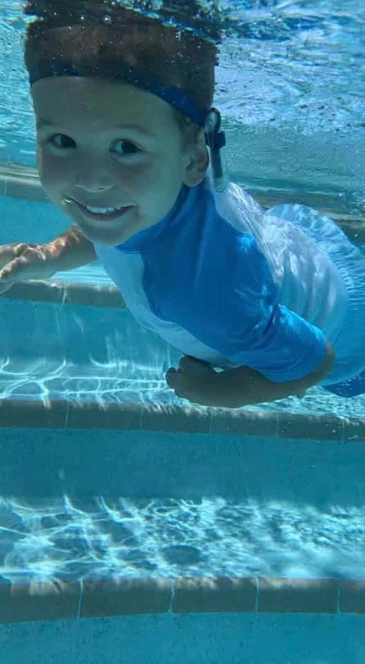 Carson, a child who failed his newborn hearing screenings, in the pool