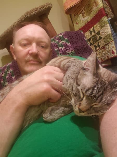 Steven, Nucleus 22 implant recipient, enjoys listening to his cat purr with his Nucleus 7 Sound Processor.