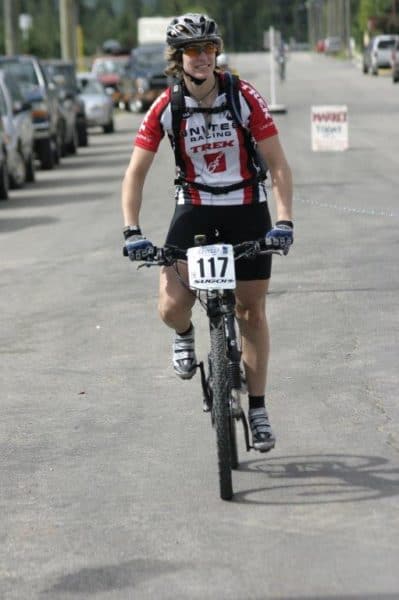 Caroline rides her bike wearing a helmet with a cochlear implant