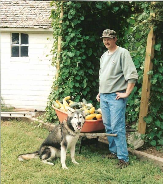 Nucleus 22 implant recipient stands outside with his dog.