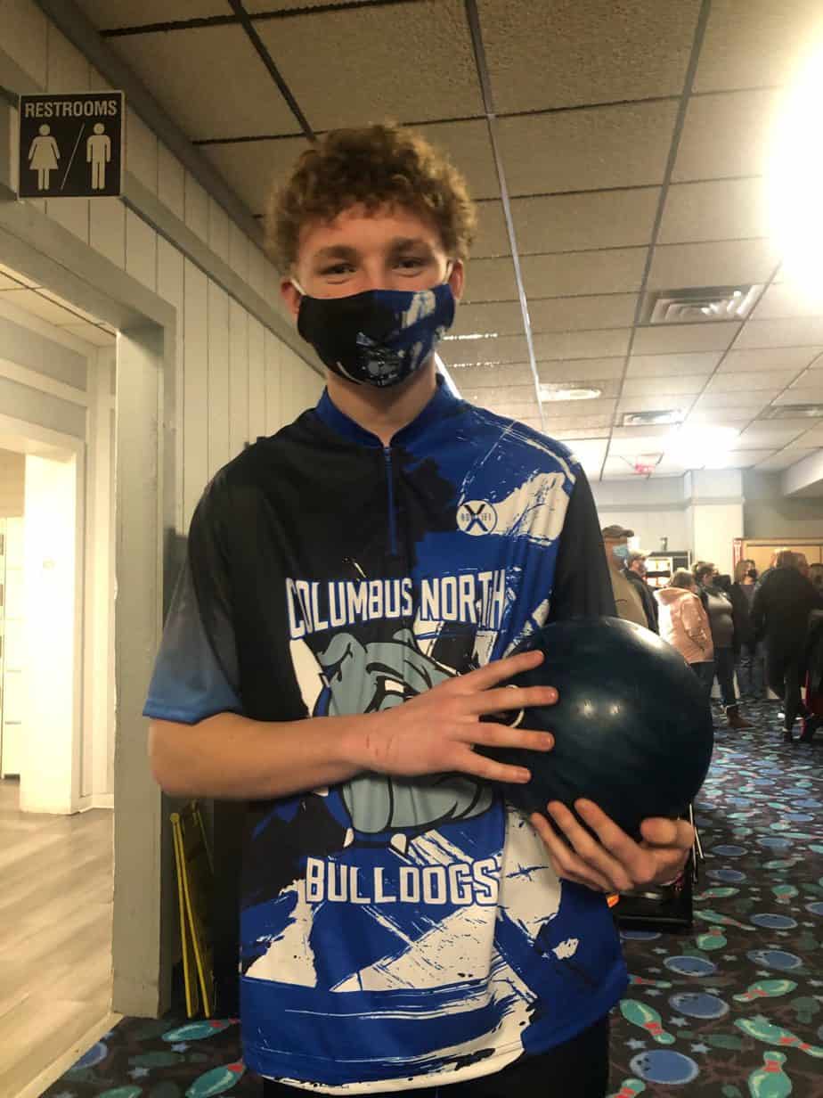 Andrew, who had early intervention, with a bowling ball