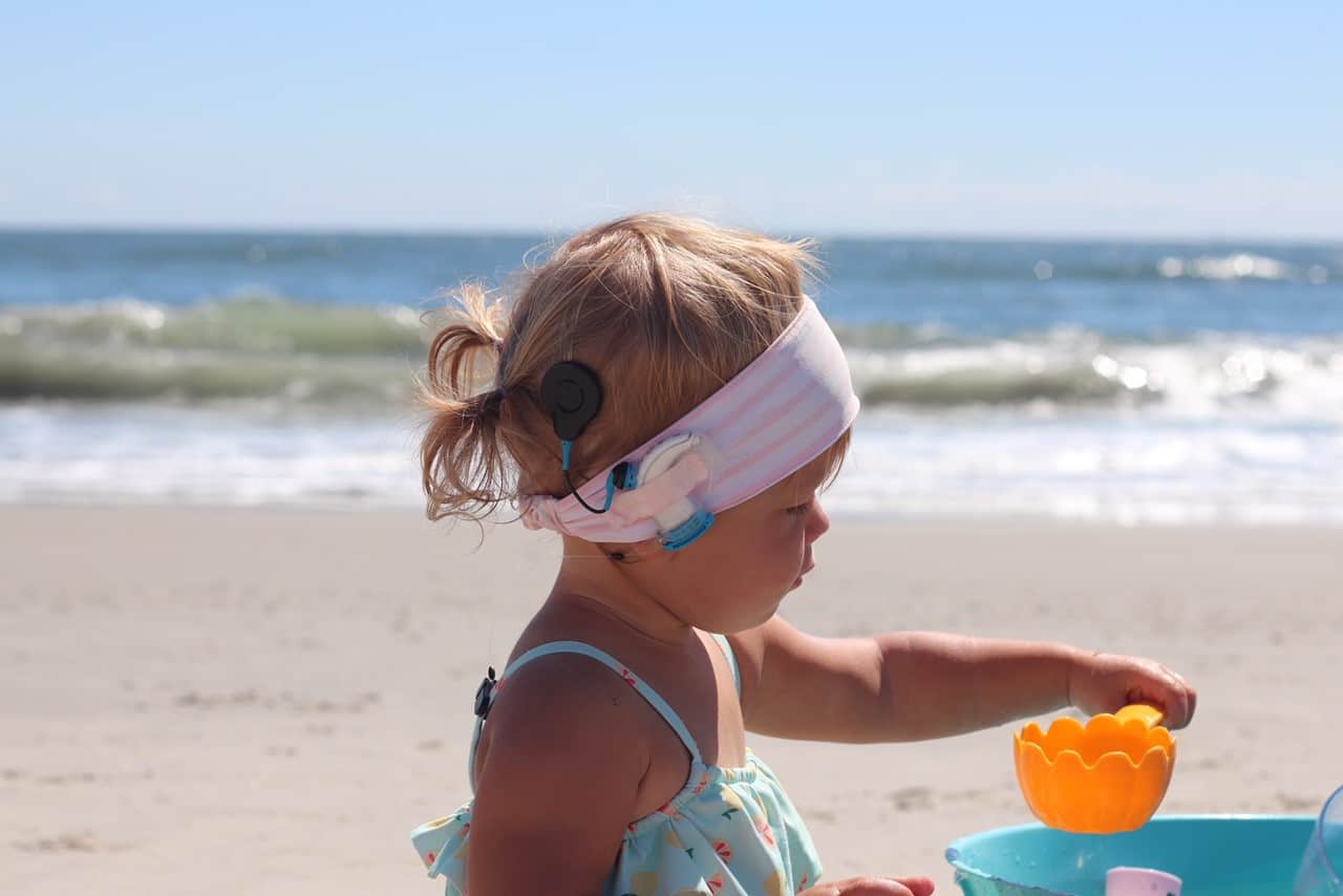 Child who lost her hearing due to meningitis at the beach