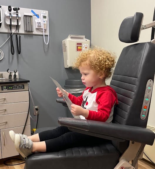 Cece, a child with profound hearing loss, in a doctor's chair
