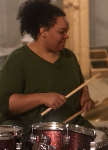 Emily, who has hearing loss from otosclerosis, playing the drums