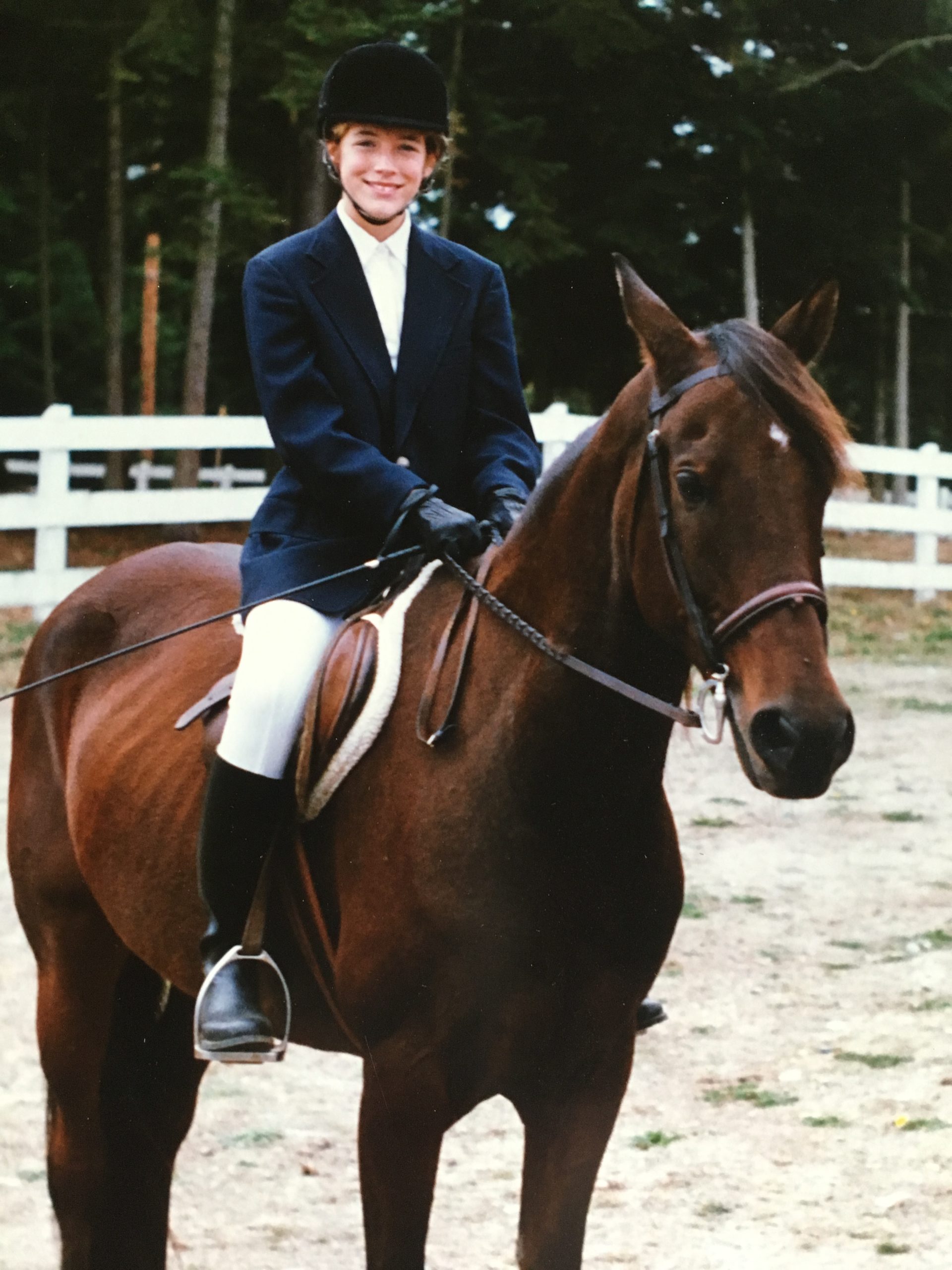 Heidi, an early cochlear implant recipient, on a horse
