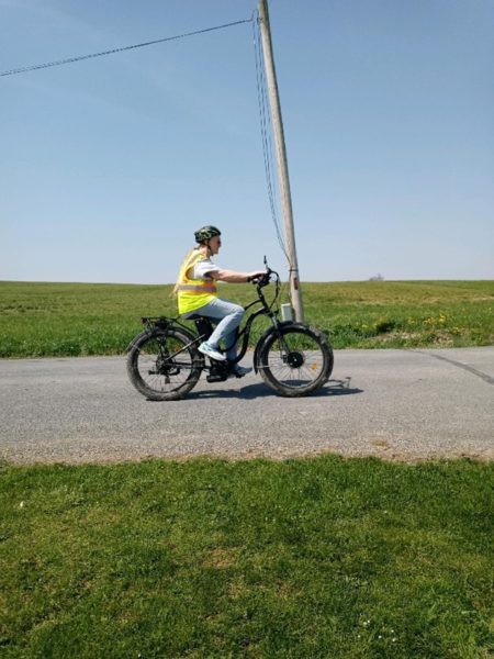 Lyn rides her bike and is proud to travel and hike with her baha system.