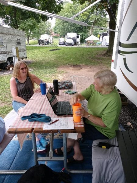 Lyn sits with her friend talking about travel and hiking with a baha system