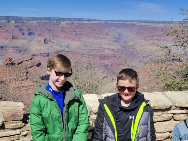 Max, a teen with microtia, standing next to his brother 