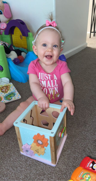 A picture of Giada, playing with children's toy's, who was diagnosed with profound hearing loss. 