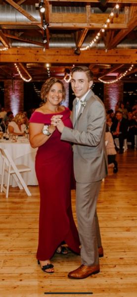 Roxanne a woman with SSD and sensorineural hearing loss dancing with her son