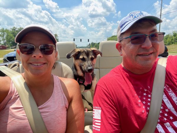 Roxanne a woman with SSD and sensorineural hearing loss in the car with her husband and dog