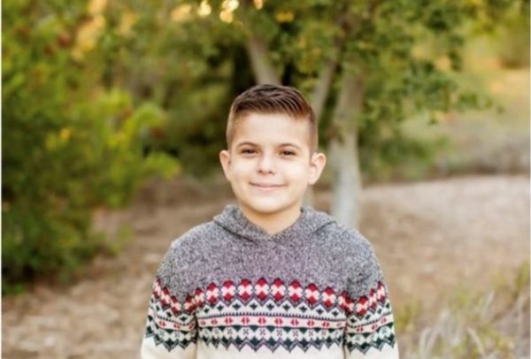 Evan smiling going back to school with his cochlear implant