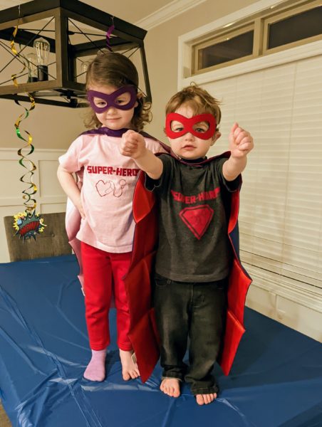 Jack, a child with bilateral profound hearing loss and his sister in super hero costumes. 