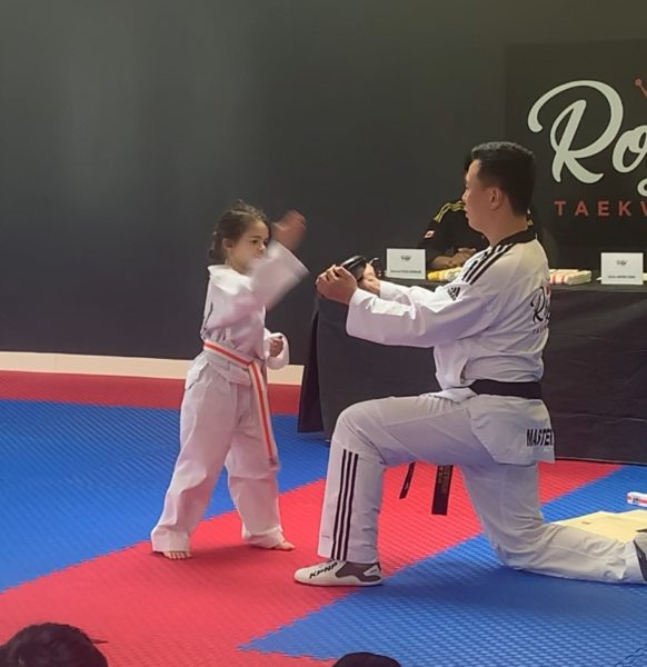 Gia, a girl with deteriorating hearing loss competing in Taekwondo