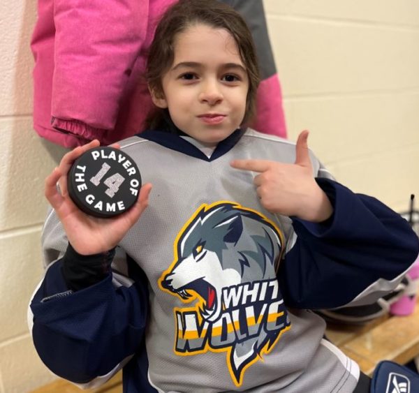 Gia, a girl with deteriorating hearing loss in Hockey pads