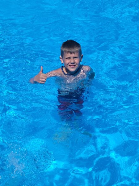 Carson, who failed his newborn hearing test, swimming in the pool 
