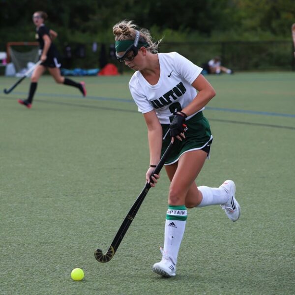 Katelyn who struggled finding a hearing solution for her cholesteatoma, playing field hockey. 