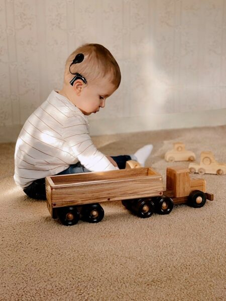 Mathias who failed his auditory brainstem response test, playing with a toy train. 