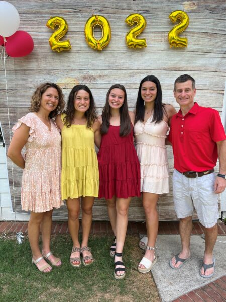 Alana, who is profoundly deaf from connexin 26, posing with her family for a photo. 