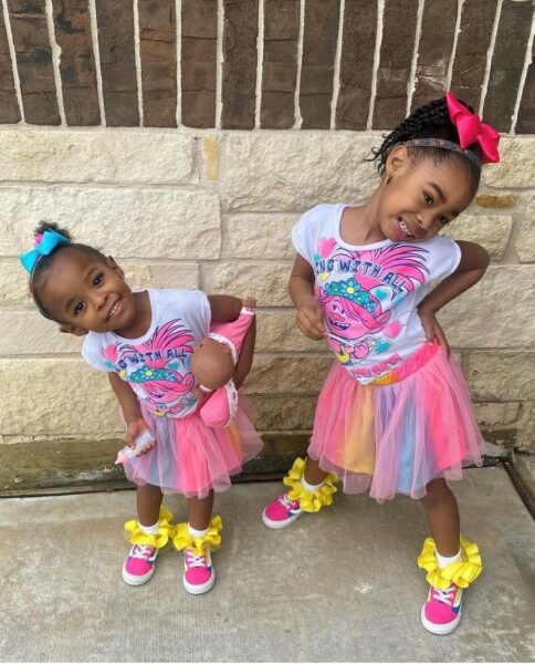 Chloe and Zoey, siblings with hearing loss wearing tutus. 