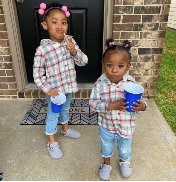 Chloe and Zoey, siblings with hearing loss posing for a picture together.