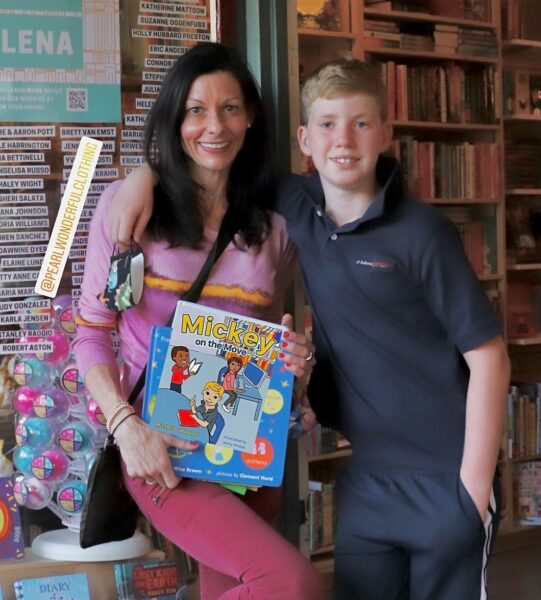 Mickey and Mom, Michelle, at bookstore holding Mickey on the Move, children's book about hearing loss