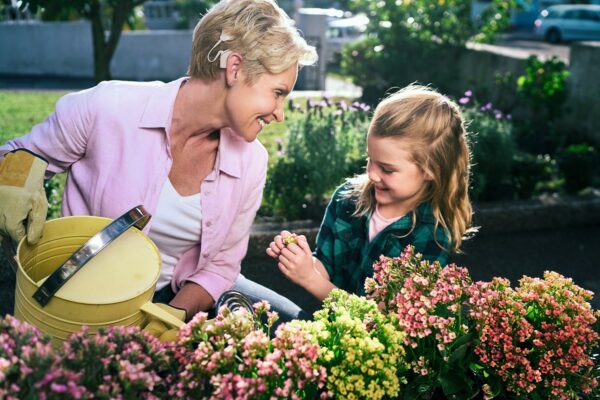 Tips for hearing in noise; recipient and child in garden watering flowers
