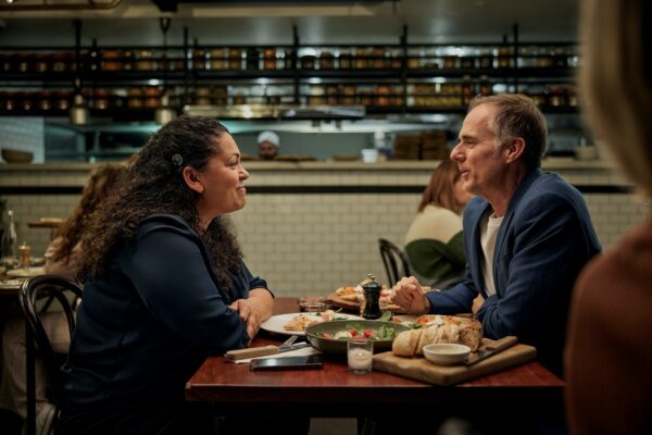 A Nucleus 8 Sound Processor recipient talking with a friend at a busy restaurant. The ForwardFocus, a feature we delivered on from the Cochlear tech wish list, enhances your listening experience in a noisy environment.