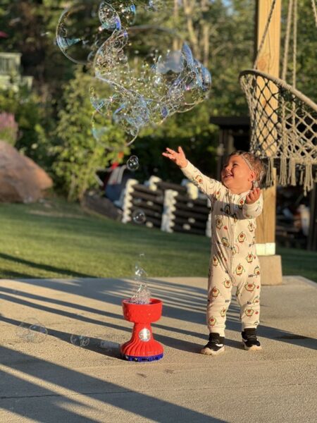 Joey who has profound hearing loss with gjb2 playing with bubbles. 