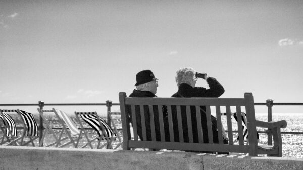 Man and Woman sit side by side to practice aural rehab. 