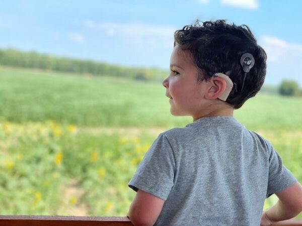 Miles, whose parents sought early intervention for their child, staring into a field. 