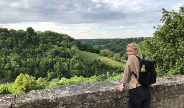 Sylwia, Cochlear employee with hearing loss outside on a stone bridge