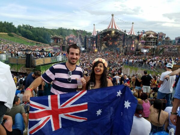 Lewis, Cochlear employee shares his story, at a concert in Belgium, holding Australian flag