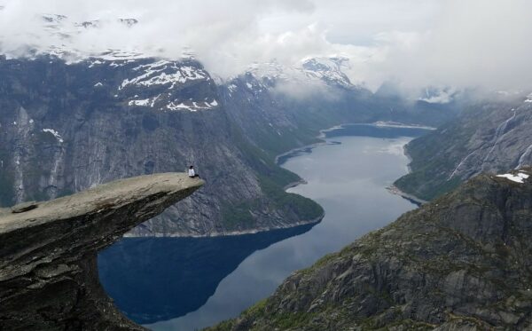 Lewis, Cochlear employee shares his story, with wife on a cliff in Norway