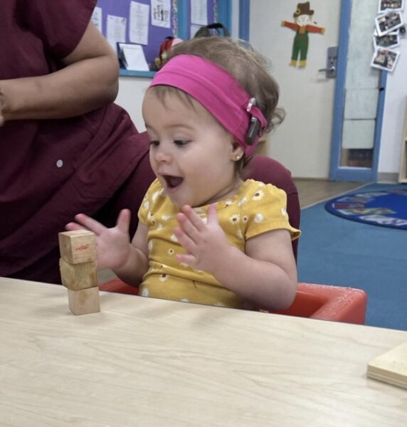 Penelope, who is deaf in both ears, playing with blocks at her Auditory Oral School.