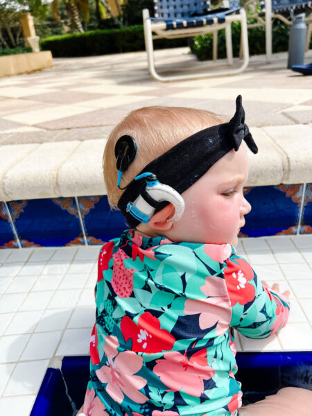 Ava, who has bilateral sensorineural hearing loss from MYO15A in the pool with her Aqua+ Kit. 