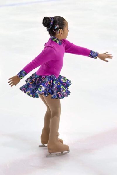 Ariana who has profound hearing loss from the myo15a gene doing a twist while figure skating