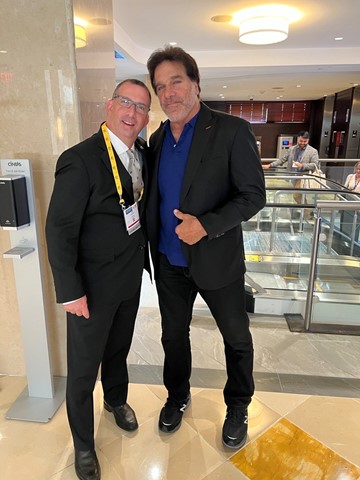 Sam, Cochlear employee with hearing loss, with Lou Ferrigno
