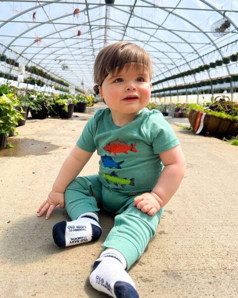 Wyatt, whose Baha System was covered by his insurance posed with his Baha Sound Processor on a Softband in a garden. 